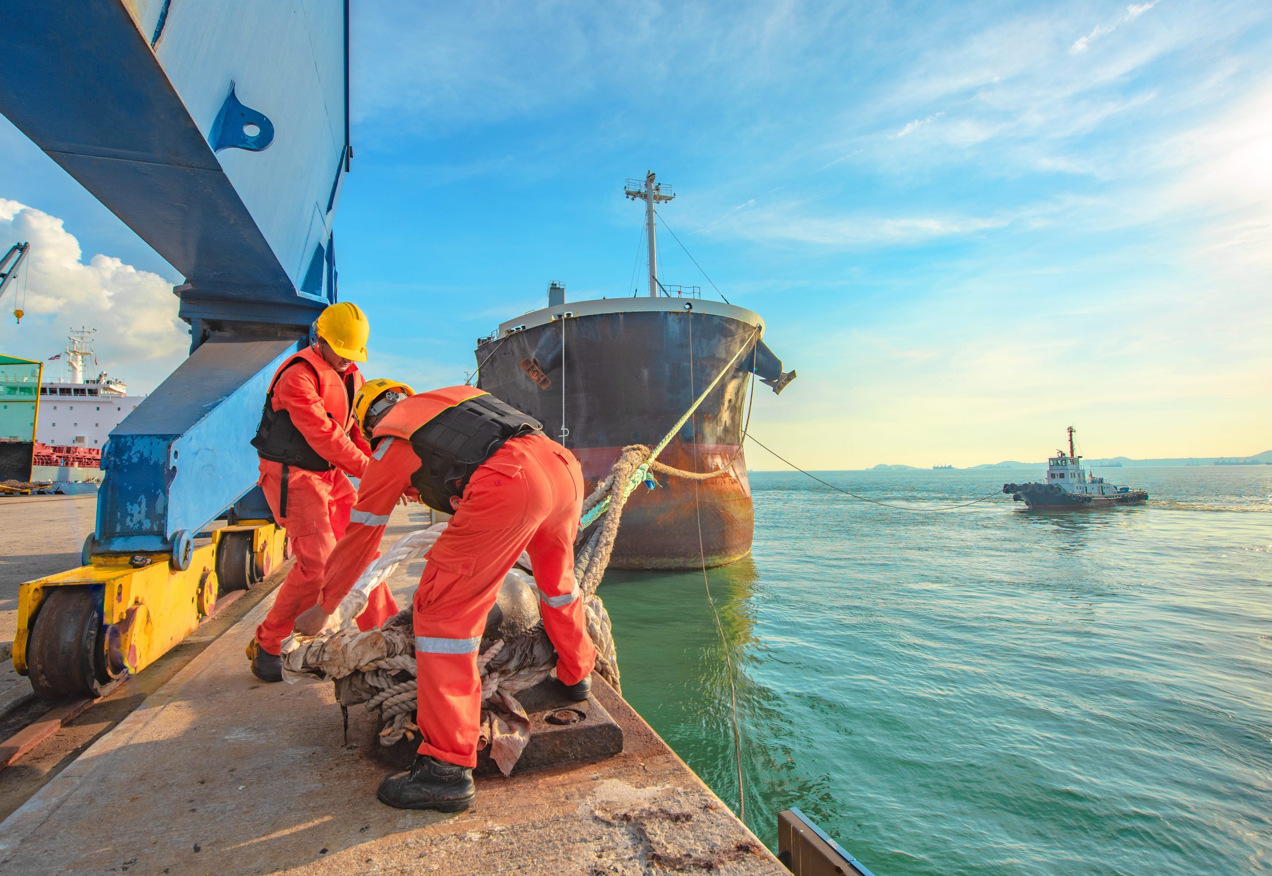 ShowEquip covers the Maritime sector / industry. Image of shore staff handling mooring lines for a large ship.
